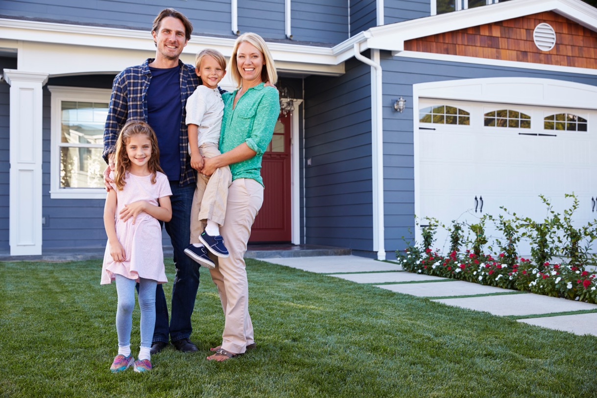 Family in front of Orange County home they just moved into